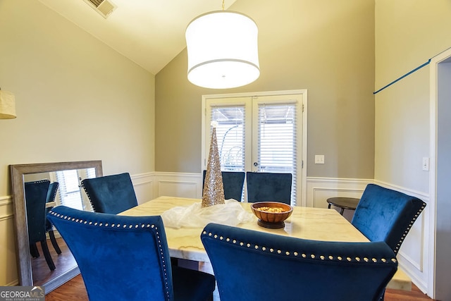 dining space featuring dark hardwood / wood-style floors and lofted ceiling