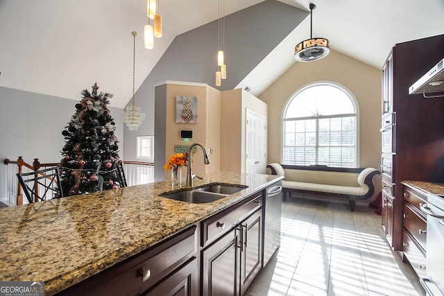 kitchen with light stone countertops, sink, high vaulted ceiling, dishwasher, and hanging light fixtures