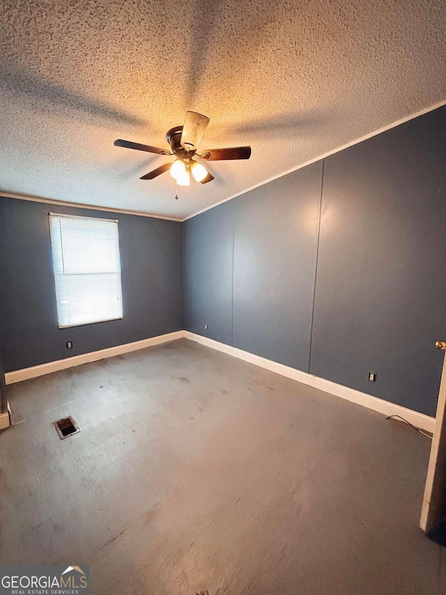 empty room with ceiling fan, a textured ceiling, and ornamental molding