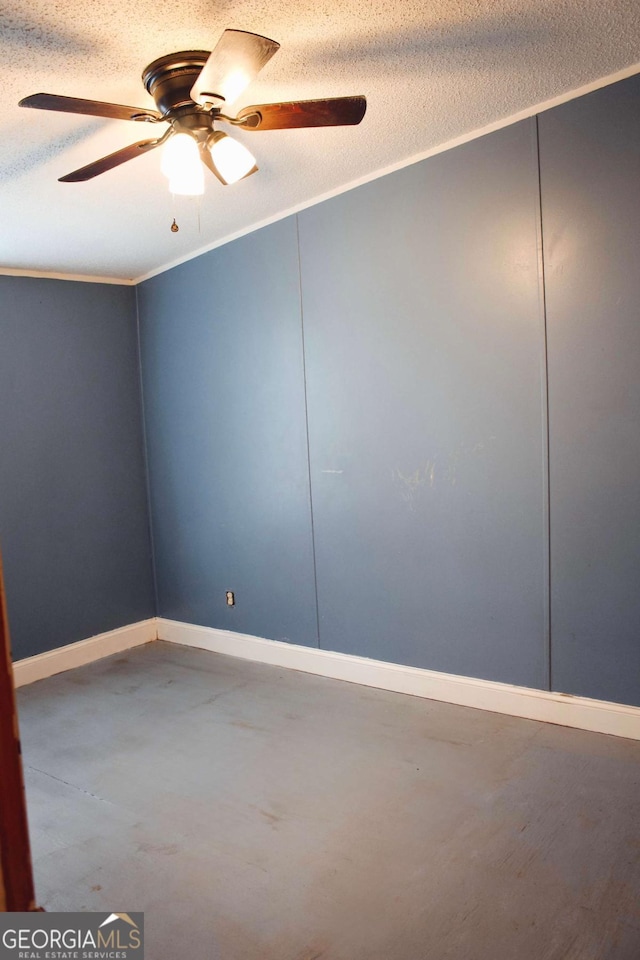 empty room featuring concrete flooring, a textured ceiling, ceiling fan, and ornamental molding