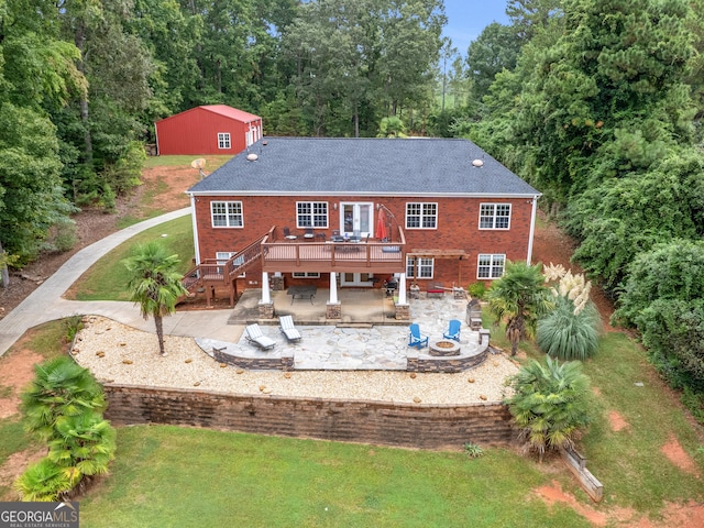 rear view of house featuring a lawn, a patio area, and a deck