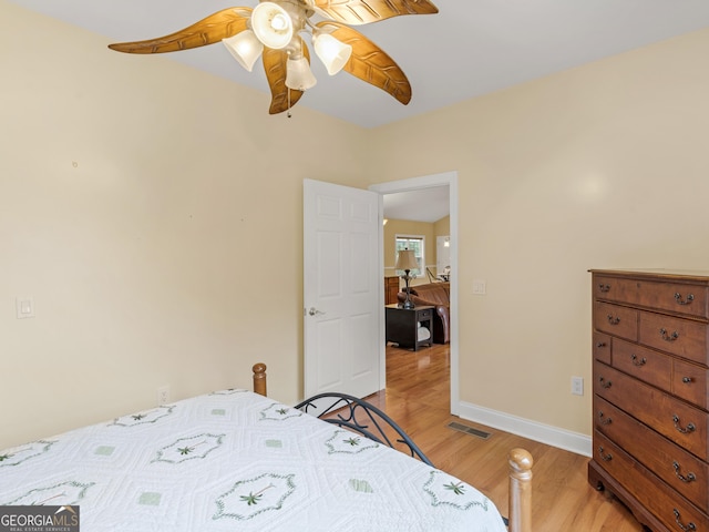 bedroom with ceiling fan and light wood-type flooring