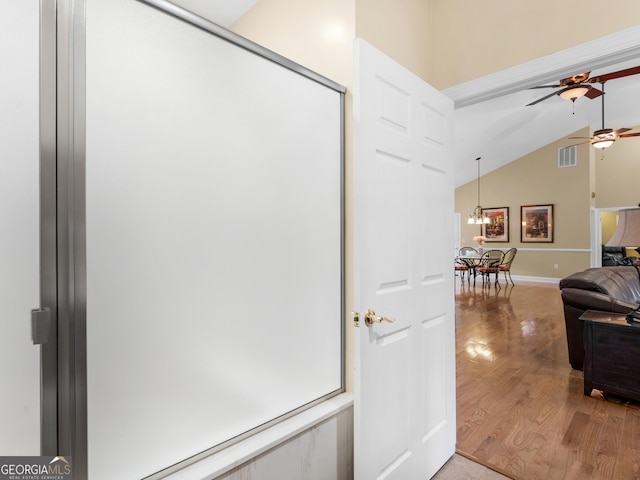 interior space with hardwood / wood-style floors, vaulted ceiling, and ceiling fan