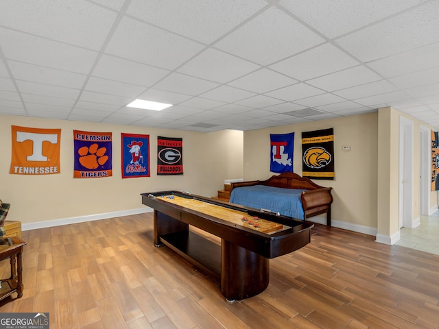 rec room featuring a drop ceiling and hardwood / wood-style flooring