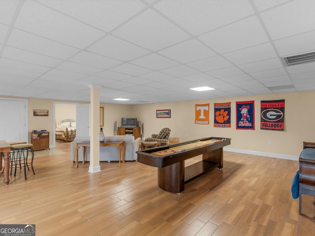 playroom featuring hardwood / wood-style floors and a drop ceiling