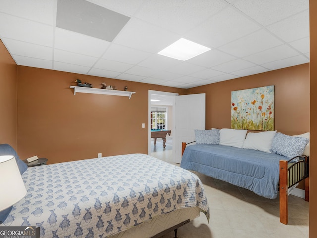 bedroom featuring a drop ceiling and billiards