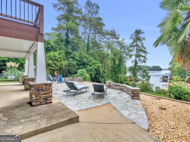 view of patio / terrace with a water view and a balcony