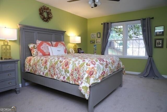 carpeted bedroom featuring ceiling fan