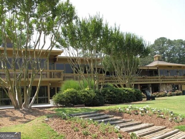 rear view of house featuring a yard