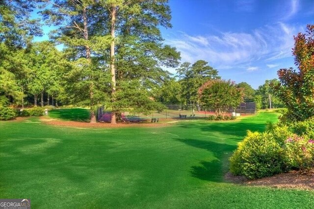 view of home's community featuring a lawn