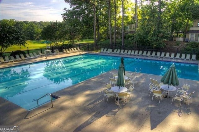 view of swimming pool with a patio area