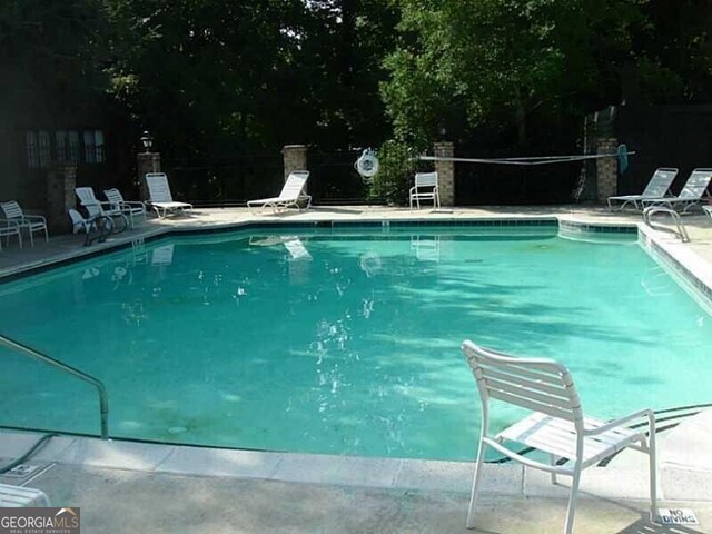 view of swimming pool with a patio