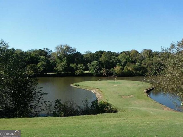 view of community featuring a yard and a water view