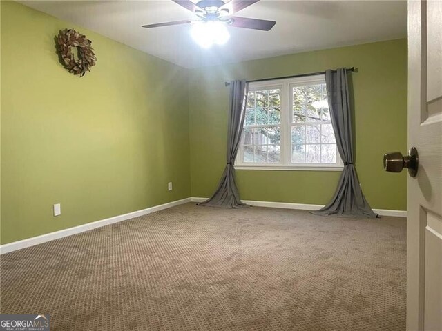 carpeted empty room featuring ceiling fan