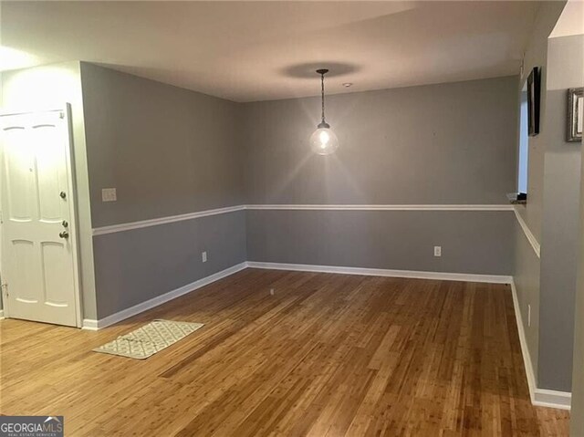 unfurnished dining area featuring hardwood / wood-style flooring