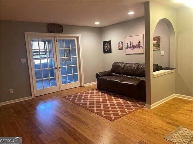 sitting room featuring french doors and hardwood / wood-style flooring