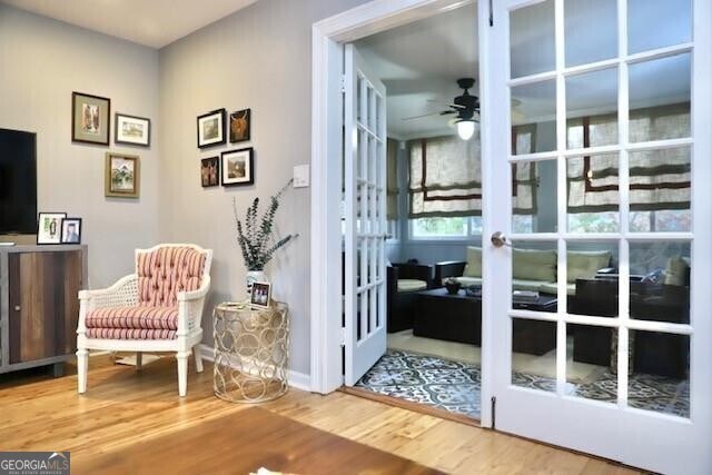 entryway with ceiling fan, french doors, and hardwood / wood-style flooring