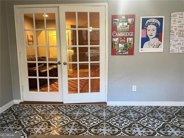 entryway featuring tile patterned floors and french doors