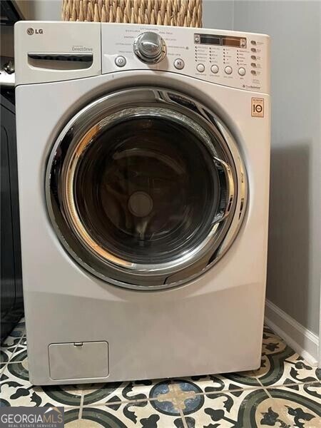 washroom with tile patterned floors and washer / clothes dryer