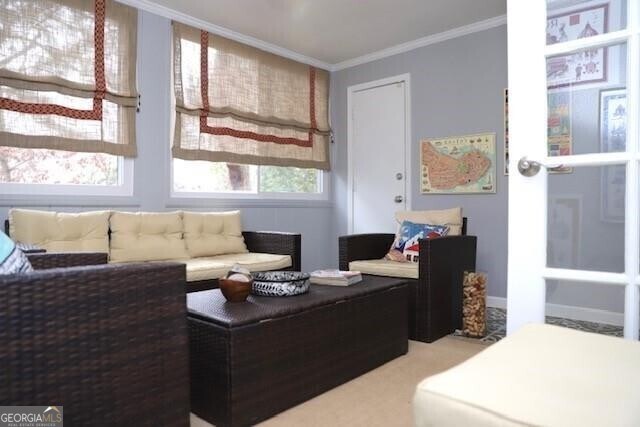 living room with a healthy amount of sunlight and ornamental molding