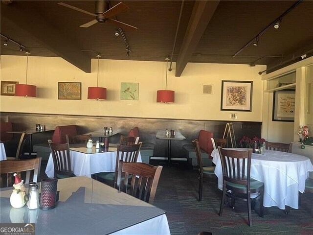 dining area featuring beamed ceiling, ceiling fan, wood ceiling, and track lighting