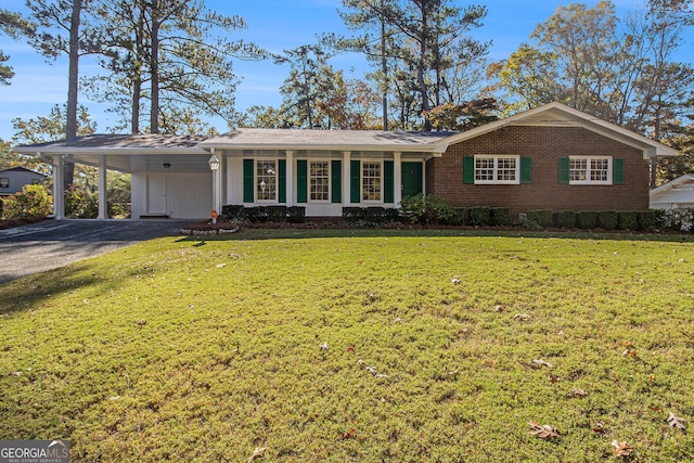 ranch-style home with a carport and a front yard