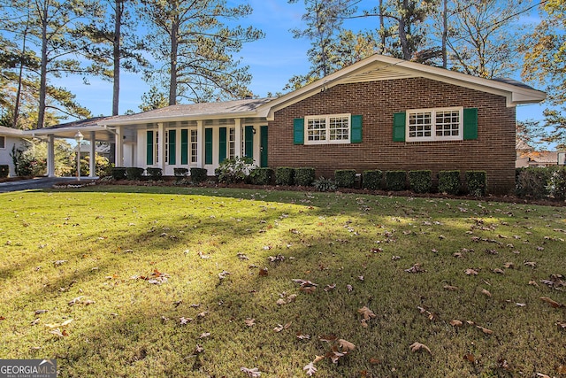 2540 Thornton Dr, Atlanta, GA 30349 - ranch-style house with a front yard and a carport
