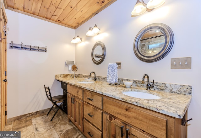 bathroom featuring baseboards, double vanity, wooden ceiling, and ornamental molding