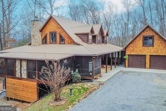 view of front of house with a garage and a sunroom