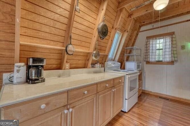 kitchen featuring light wood-type flooring, visible vents, light countertops, and electric stove