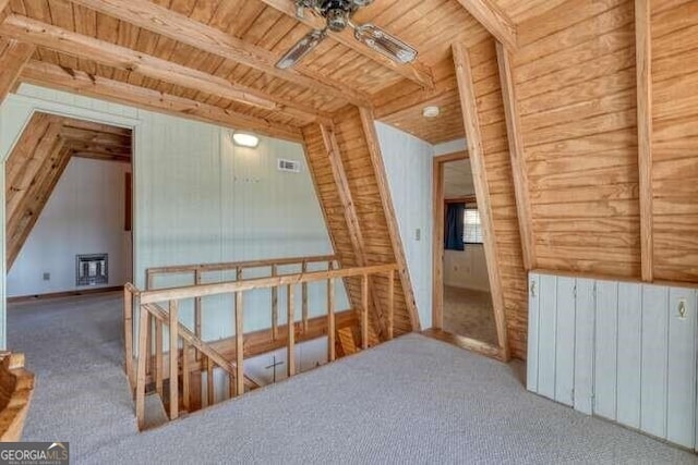 additional living space with carpet floors, wood ceiling, radiator, and visible vents