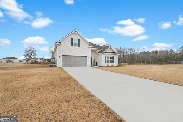 view of property with a front yard and a garage