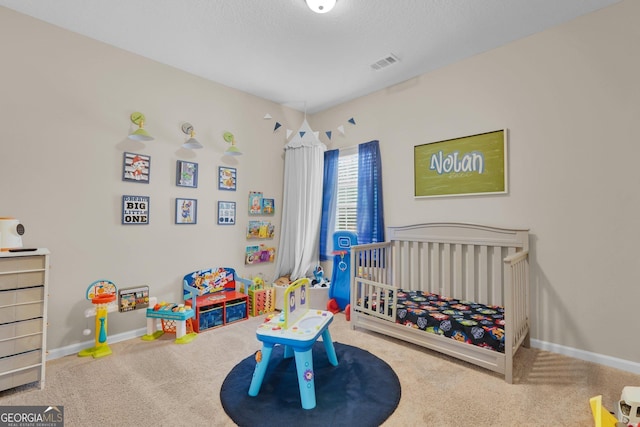 carpeted bedroom featuring a crib