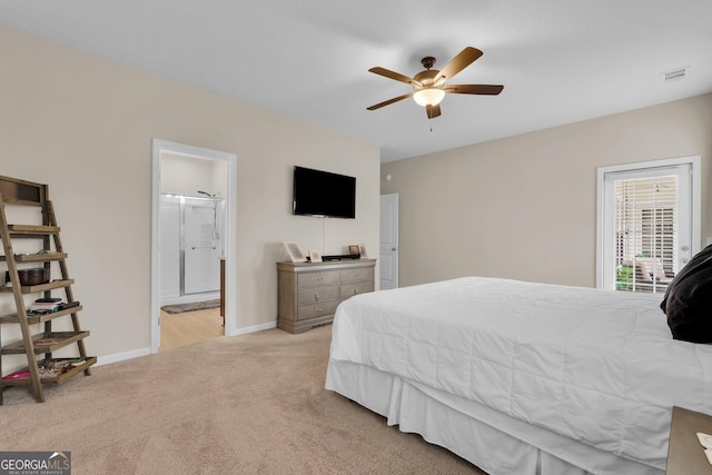 bedroom with ensuite bathroom, ceiling fan, and light colored carpet