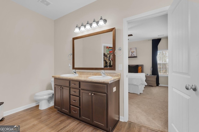 bathroom featuring hardwood / wood-style floors, vanity, and toilet