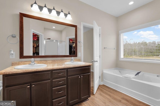 bathroom featuring separate shower and tub, vanity, and hardwood / wood-style flooring