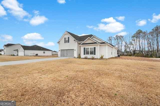 view of front of house with a front yard and a garage