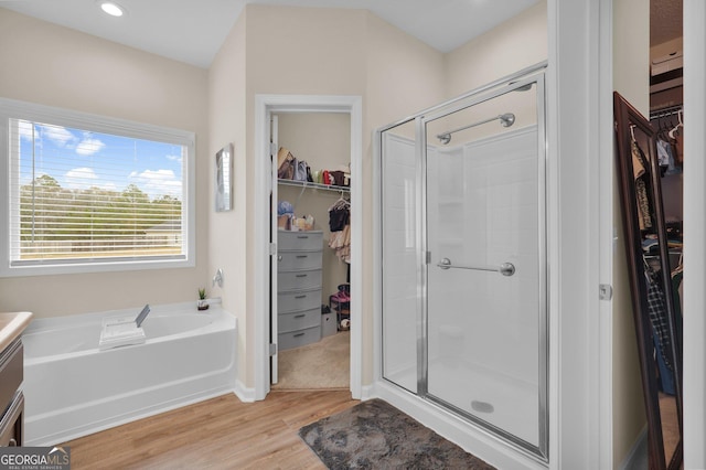 bathroom with vanity, wood-type flooring, and shower with separate bathtub