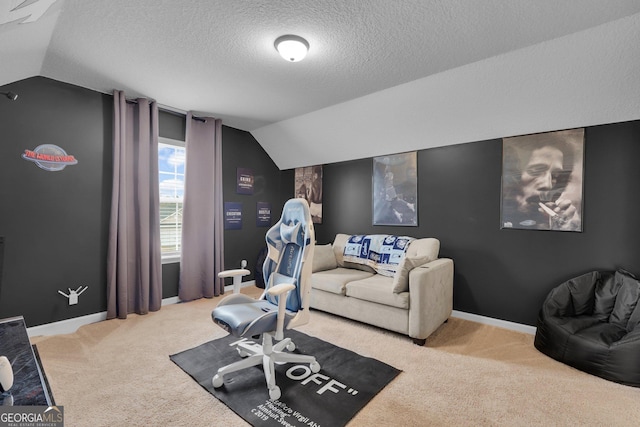 interior space with a textured ceiling, light carpet, and vaulted ceiling