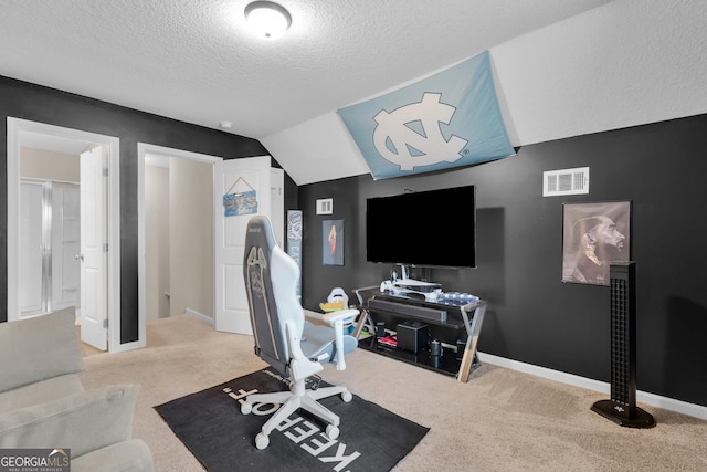 carpeted office space featuring a textured ceiling and vaulted ceiling