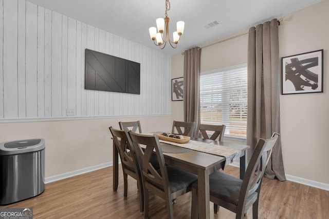 dining area featuring a chandelier and light hardwood / wood-style floors