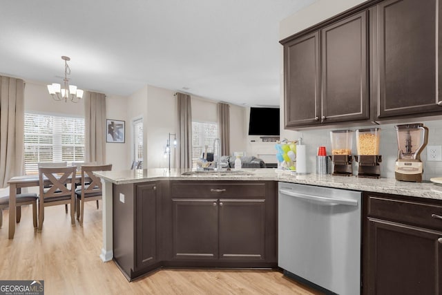 kitchen with dishwasher, a notable chandelier, backsplash, sink, and dark brown cabinets