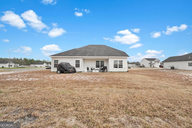 rear view of house featuring a yard and a patio area