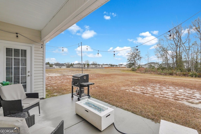 view of patio / terrace featuring a grill and a fire pit