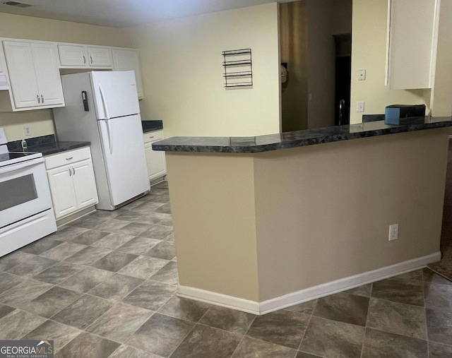 kitchen with white cabinets, white appliances, kitchen peninsula, and dark stone counters