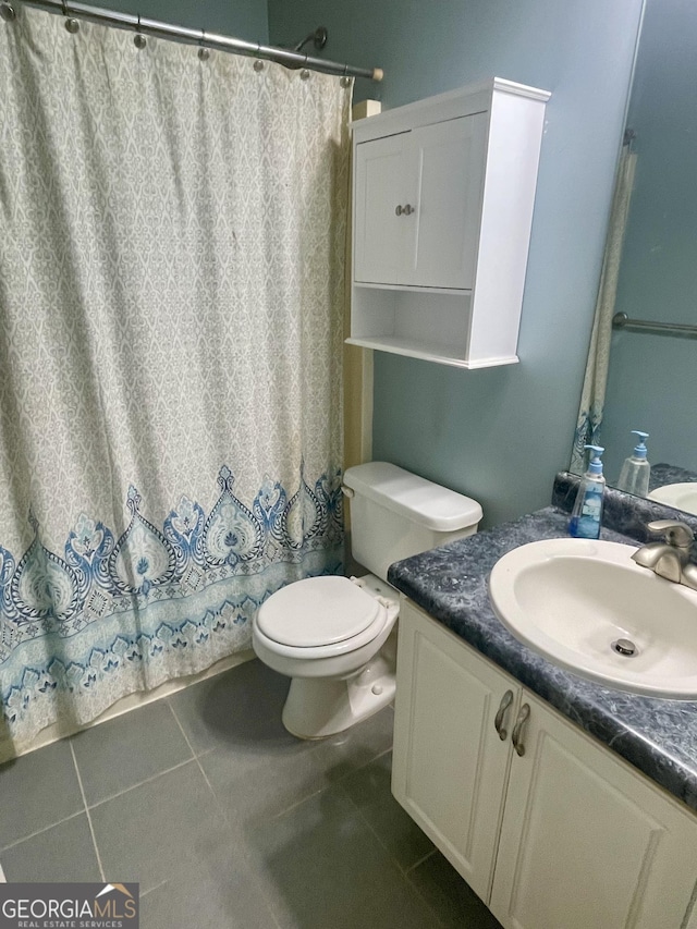 bathroom with tile patterned floors, vanity, and toilet