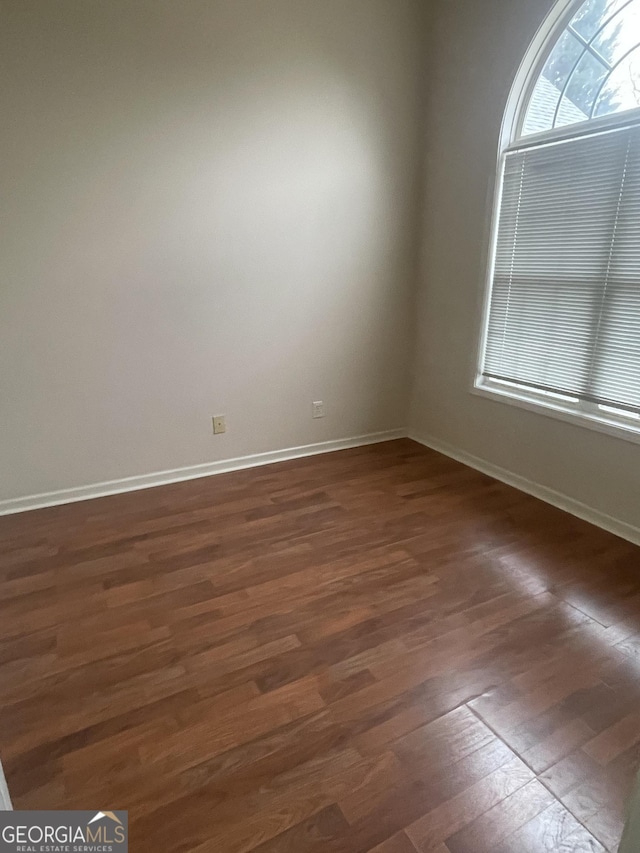 spare room featuring dark hardwood / wood-style floors