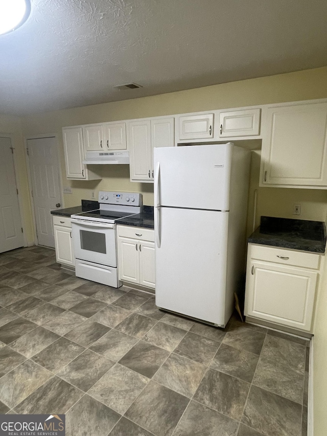 kitchen with white cabinets, white appliances, and a textured ceiling