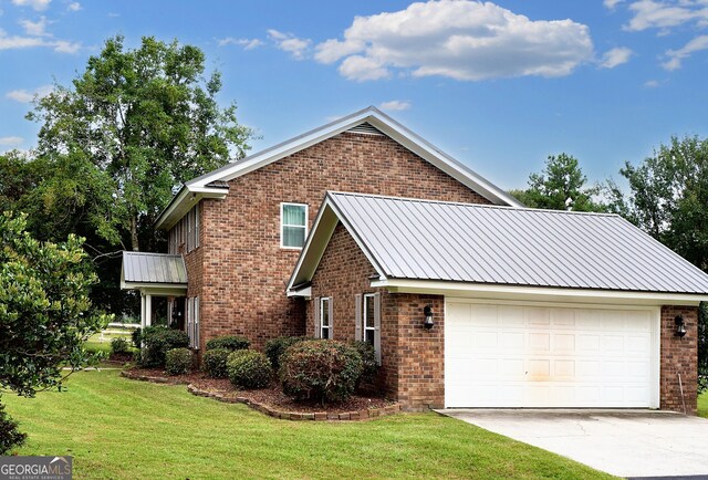 front of property with a garage and a front lawn