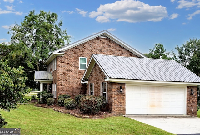 traditional-style house with brick siding, driveway, metal roof, and a front lawn